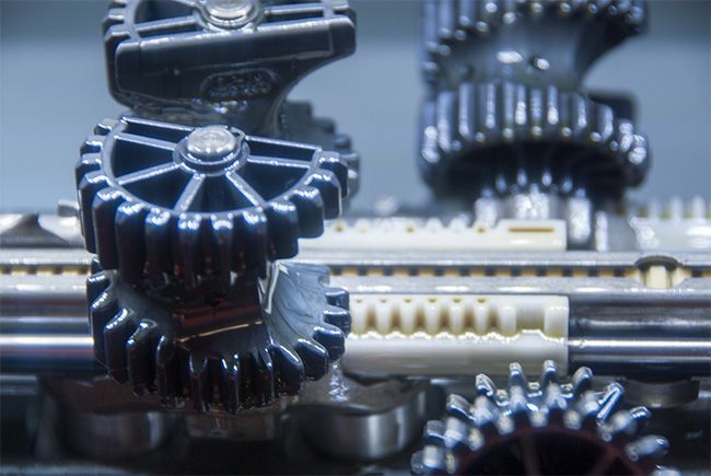 Entreprise - Photographie des rouages d'une machine industrielle pour l'entreprise de décolletage J. Baertschi SA